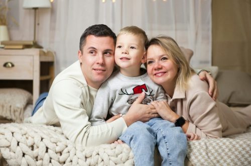 a man and woman with a child on a couch