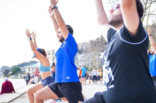 Group performing yoga outdoors along the scenic waterfront in İstanbul, Türkiye.